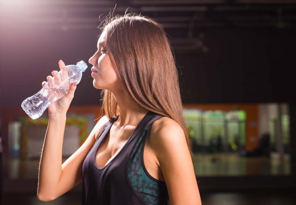 fitness woman drinking water from bottle