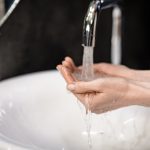 Improve hygiene in your bathroom with smart solutions Unrecognizable Woman Washing Hands During Pandemic In Bathroom Indoor, Closeup